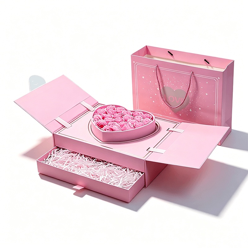 Pink gift drawer box with drawer open and white shredded paper